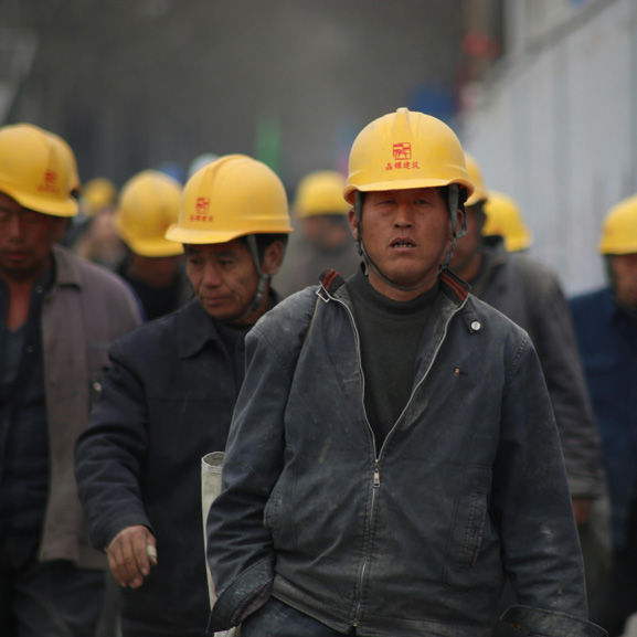 Oil Field workers with yellow hard hats